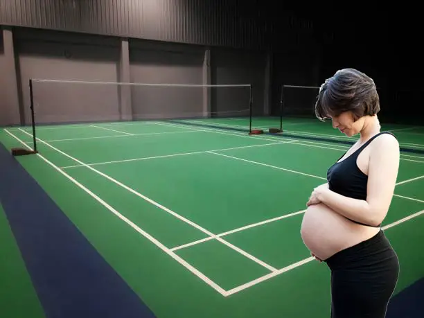 pregnant woman playing badminton